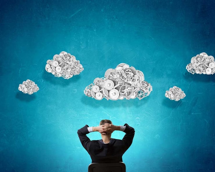 Thoughtful-businessman-with-gear-mechanisms-above-his-head