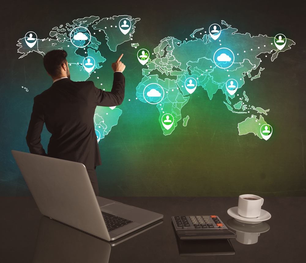 A young business manager working on a global sales strategy and drawing on illustrated map of the world concept