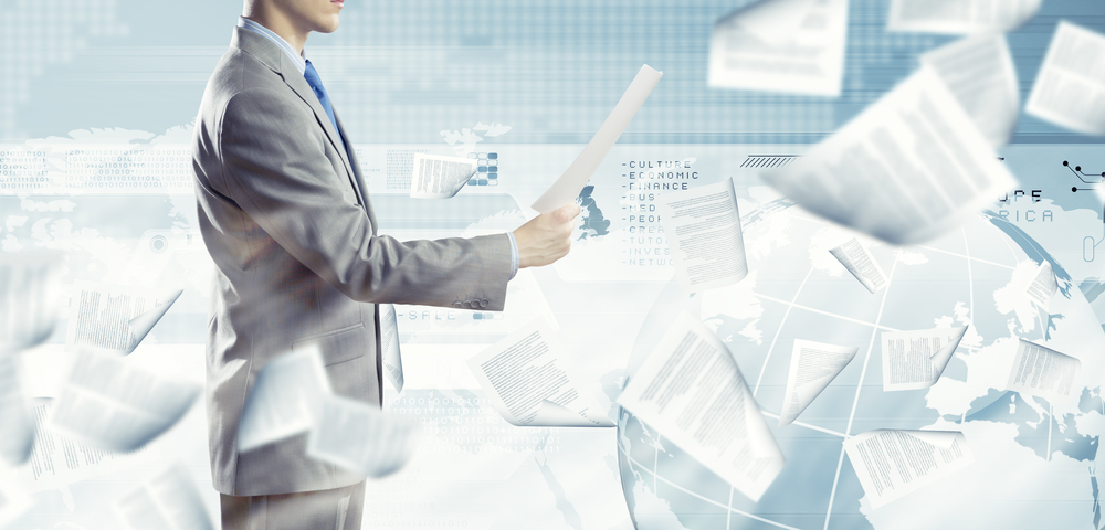 Back view of businessman reading documents in hand