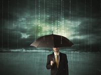 Business man standing with umbrella data protection concept on background-1