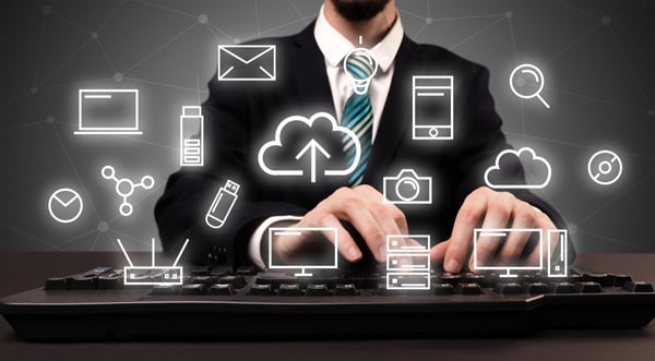 Businessman in suit typing with multimedia concept above