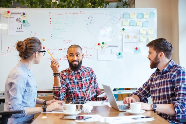 Multiethnic group of young people sitting in conference room and brainstorming on business meeting.jpeg