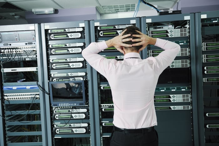 it business man in network server room have problems and looking for  disaster situation  solution